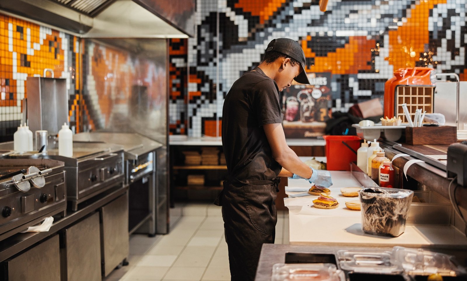A cafe worker preparing food behind the counter